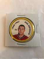 Front side of the hockey coin showing Phil Esposito's portrait and identifying text.