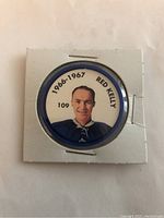 Front side of the hockey coin showing the color portrait of Red Kelly, text '1966-1967 Red Kelly' and the number '109'. This shows the key identity and design of the coin.