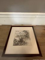 Full view of framed Chinese winterscape painting on wooden surface showing the winter scene and mat