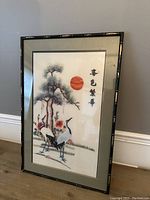 Framed Chinese embroidered artwork featuring two cranes with pine tree and red sun, front view