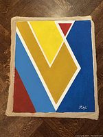 Full view of the oil painting on canvas laid on wooden floor showing unframed edges and canvas border