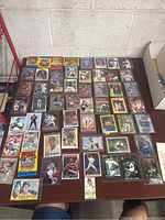 Top spread of various sports trading cards and packs laid out on a table showing different players and sports.
