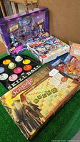Full view of game and toy lot including Scrabble Hobbit edition, Skill Ball game, Star Wars figures, Connect 4, and small toys