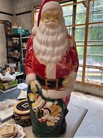 Front view of vintage Empire Santa blow mold showing red suit, white beard, and sack of toys.
