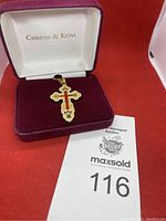 Cross pendant necklace displayed in a Camrose & Kross-branded velvet box.
