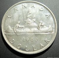 Photo of the reverse side showing the canoe scene with the year 1960 and 'CANADA DOLLAR' inscription.