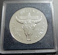 Reverse side of the 1982 Canadian silver commemorative $1 coin showing bison skull, parliament building image, and date inscriptions