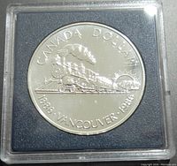 Obverse side of the 1986 silver Canadian $1 commemorative coin featuring a steam locomotive and inscriptions.