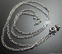 Image showing the full length of the twisted Figaro chain necklace with spring ring clasp.