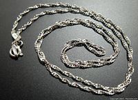 Full view of coiled sterling silver rope chain necklace showing chain design and clasp.