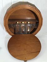 Front open view showing three glass bottles labeled 'Karoff' and four shot glasses mounted inside wooden keg-shaped bar.