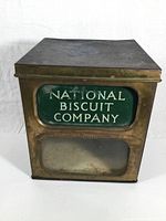 Front view of vintage National Biscuit Company metal box with glass panel and enamel sign on front.