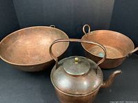Overview showing three copper items: tea kettle, large bowl, hammered pot