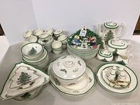Various Spode Christmas Tree pattern dinner and serveware arranged against white background