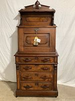 Full front view of assembled desk showing overall appearance and finial top