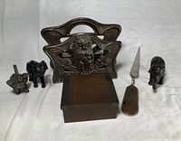 Full lot overview with letter holder, brass box, letter opener, and three metal elephants.