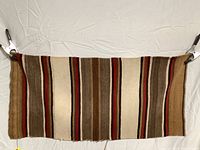 Full view of Navajo weaving showing horizontal striped pattern and overall wear.