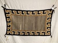 Full view of the Navajo weaving showing the entire textile with geometric pattern.