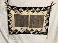 Full front view of Navajo weaving hung flat against white background