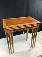Front angled view of the set with nested tables showing the painted legs and wood tops