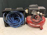 Front view showing Porter Cable 135 PSI air compressor and coiled blue air hose in black carrying case.
