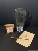 Full view of all three items: brass desk clock, hexagonal crystal vase, silverplate letter opener with cloth pouch.