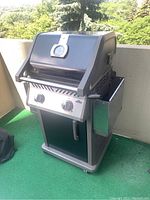 Front view of Napoleon two-burner propane grill on balcony
