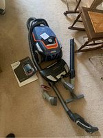 Main vacuum body with hose, two wands, floor nozzle and manual