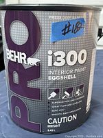 Close-up of BEHR Pro i300 paint can label showing branding, product line, finish, and features.