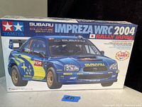 Box front showing the Subaru Impreza WRC 2004 Rally Japan model kit by Tamiya with detailed artwork of the car and series information