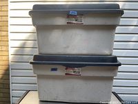 Two stacked Rubbermaid Roughneck storage bins showing overall condition and color.