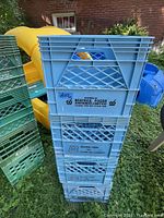 Photo showing stacked blue plastic milk crates labeled with Beatrice Foods Ontario Limited logo.
