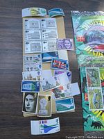 Photo showing multiple vintage stamps on a board including portraits, landmark images, and flags.