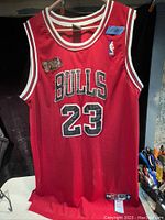 Front view of red Chicago Bulls basketball jersey with NBA Finals patch and Nike logo, number 23 on front.