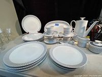 Full set of MCM porcelain dishes including all listed pieces staged on a table with black background.
