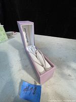 Pair of Michael Hill silver hoop earrings inside branded purple box, angled view showing overall look and presentation