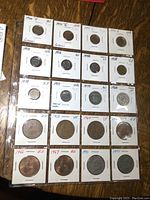 Coins in individual holders, labeled with years and conditions