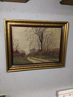 Framed oil painting showing overall view of landscape and frame