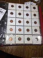 Plastic pages with consecutive year pennies from 1927 to 1963 in individual coin holders with years and grades.