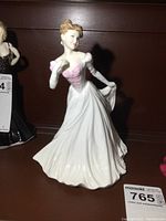 Front view of Royal Doulton The Bride porcelain figurine showing detailed gown and pink accents on bodice.