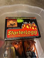 Box of StarterLog wood fire starters, 24 pack with flame graphics