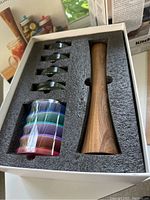 Photo of the Mason Jar Fermentation Kit contents in foam packaging showing pickle packer, pickle pebbles, and pickle pipes