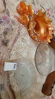 Overview of multiple glass dishes including clear bowls and amber leaf-shaped dish with small matching bowls