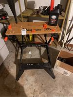 Black and Decker Workmate 200 folding workbench with wooden top and orange clamps