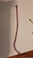 Full-length view of the bracelet on white surface showing overall length and stone arrangement