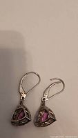 Pair of 10k stamped earrings with triangular pink stones surrounded by small clear rhinestones, leverback hooks shown on light background.