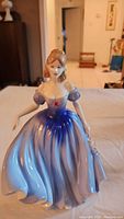 Front view of the Royal Doulton Melissa figurine showing detailed gown and posed arms.