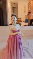 Front view of the Royal Doulton Camilla figurine in pink dress, showing detailed face and jewelry.