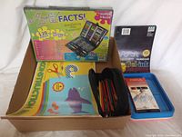 The full lot showing art fact kit, pencil case with colored pencils, drawing paper folders, gel ink sketch pad, and plastic tray.