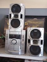 Full view of Sony stereo system with central unit and two speakers on shelf